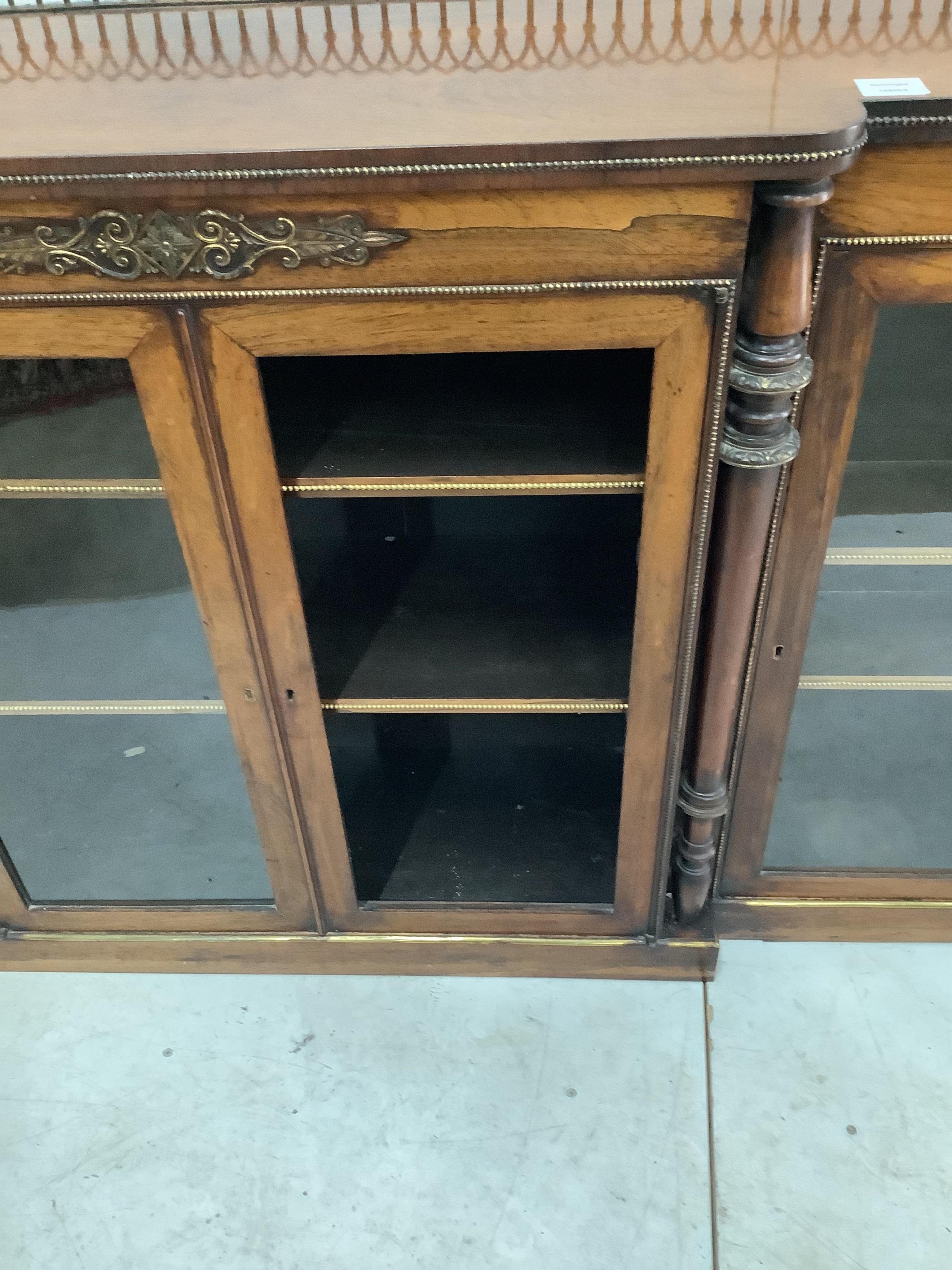 An early Victorian rosewood breakfront dwarf bookcase, width 168cm, height 97cm. Condition - one glazed panel missing, otherwise fair to good